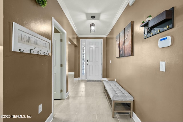 entryway featuring light tile patterned floors and crown molding