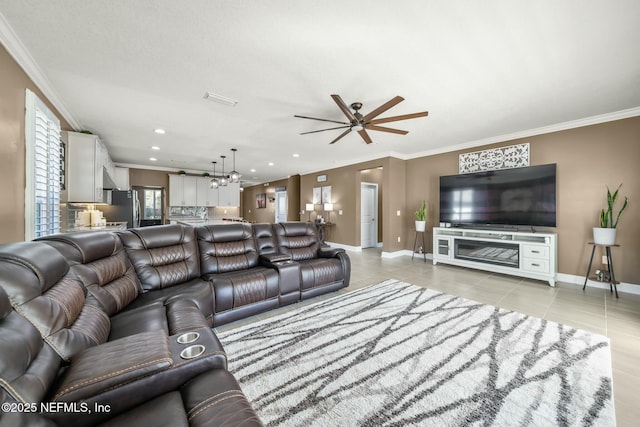 living room featuring ceiling fan, light tile patterned flooring, and ornamental molding