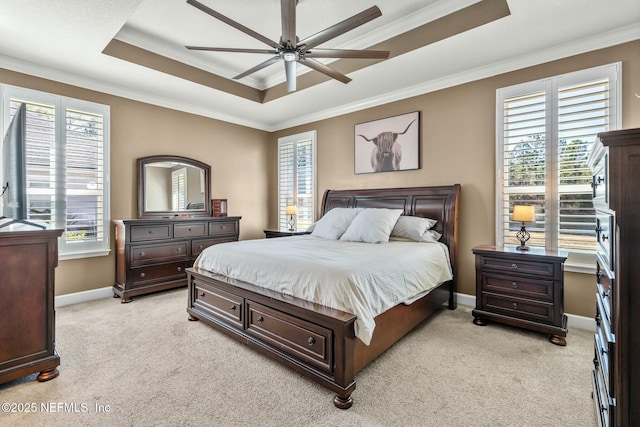 carpeted bedroom featuring ceiling fan, multiple windows, ornamental molding, and a raised ceiling