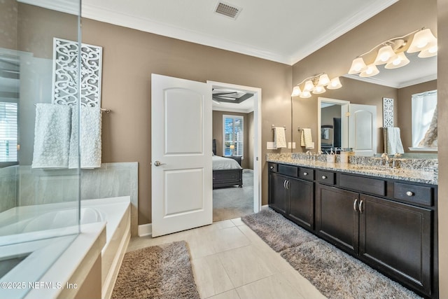 bathroom with tile patterned flooring, crown molding, a relaxing tiled tub, and vanity