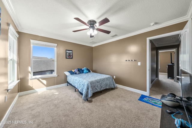 carpeted bedroom with a textured ceiling, ceiling fan, and crown molding