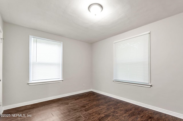 empty room featuring dark wood-type flooring