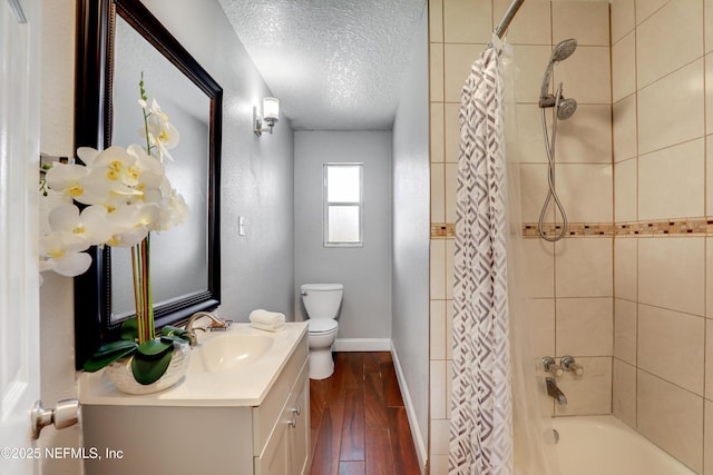 full bathroom with toilet, a textured ceiling, vanity, shower / bath combination with curtain, and hardwood / wood-style floors