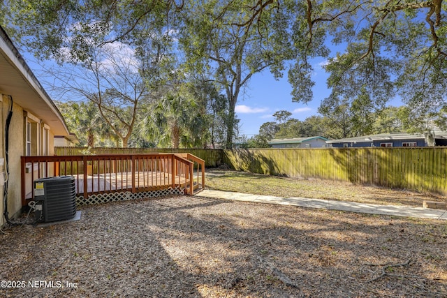 view of yard with cooling unit and a deck