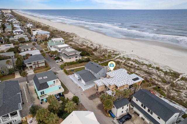 bird's eye view featuring a view of the beach and a water view