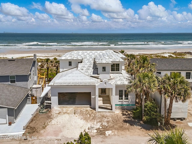 1509 Oceanfront, Neptune Beach, FL 32266 - view of front of house with a water view, a view of the beach, and stucco siding