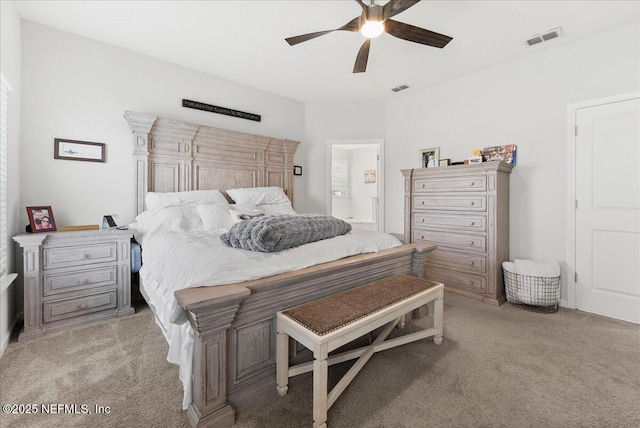 bedroom featuring connected bathroom, light colored carpet, and ceiling fan