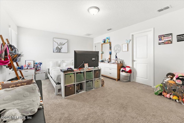 bedroom with a textured ceiling and carpet flooring