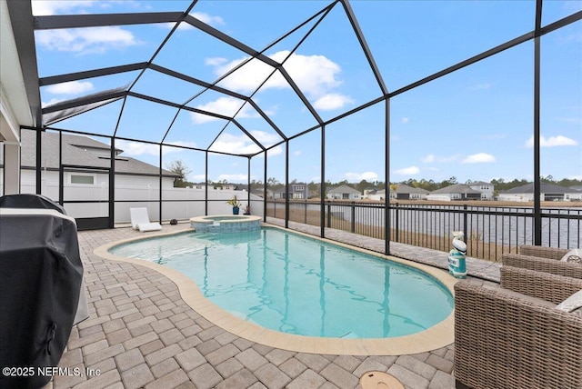 view of pool featuring grilling area, a patio, a lanai, and an in ground hot tub