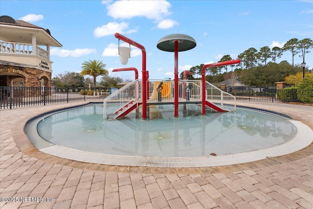 view of swimming pool featuring a playground