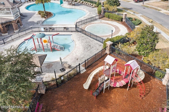 view of swimming pool featuring a playground