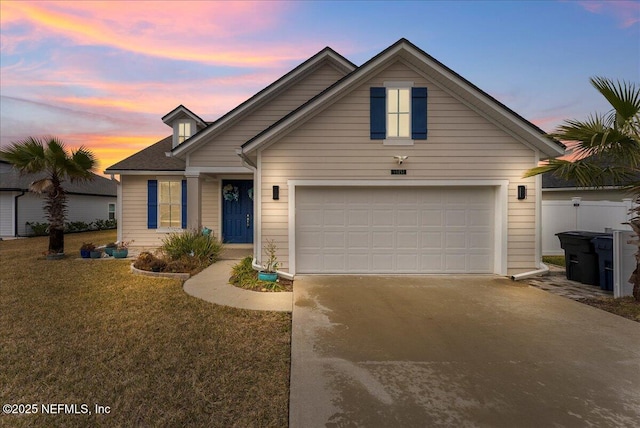 view of front of property with a garage and a yard