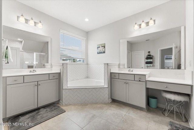 bathroom with plus walk in shower, tile patterned floors, and vanity