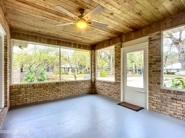 unfurnished sunroom featuring ceiling fan and wood ceiling