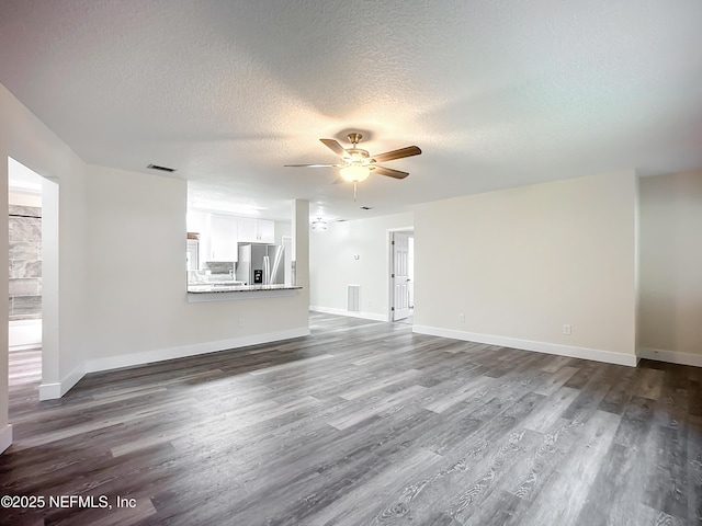 unfurnished living room with ceiling fan, a textured ceiling, and hardwood / wood-style floors