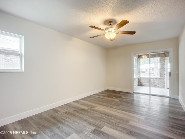 unfurnished room with a textured ceiling, ceiling fan, and hardwood / wood-style floors