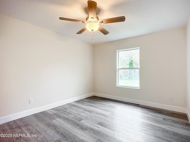 spare room featuring a textured ceiling, ceiling fan, and hardwood / wood-style flooring