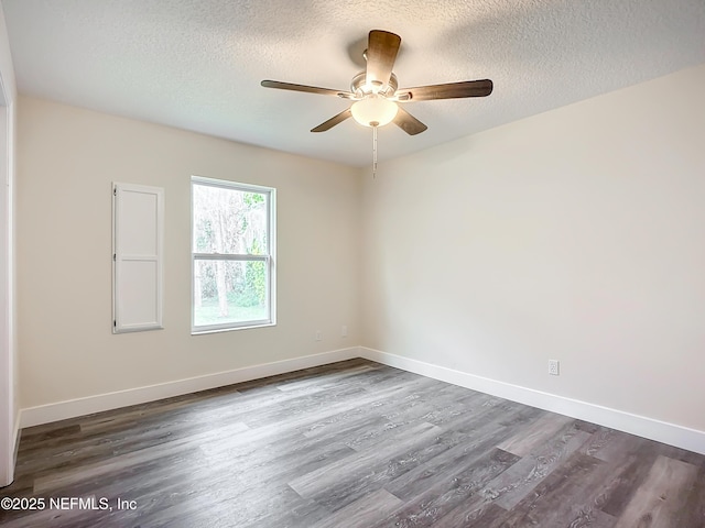 spare room featuring a textured ceiling, ceiling fan, and dark hardwood / wood-style flooring