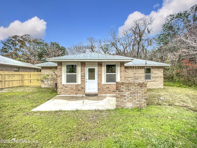 back of property featuring a yard and a patio