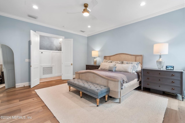 bedroom with ceiling fan, light hardwood / wood-style flooring, and ornamental molding