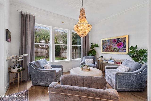 living room featuring hardwood / wood-style floors, crown molding, plenty of natural light, and a notable chandelier