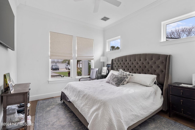 bedroom featuring ceiling fan, dark wood-type flooring, and ornamental molding