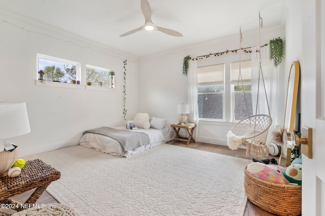 bedroom with ceiling fan, crown molding, and hardwood / wood-style floors