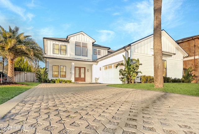 view of front of property featuring a garage and a front lawn