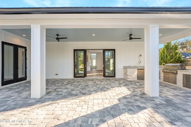 view of patio with ceiling fan, french doors, an outdoor kitchen, and area for grilling