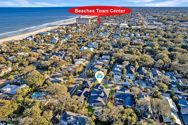 drone / aerial view with a water view and a beach view