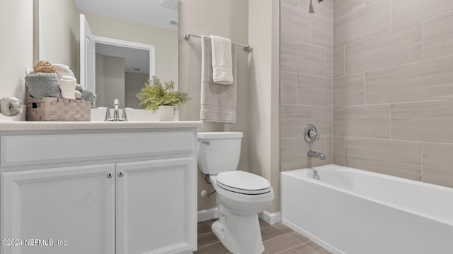 full bathroom with toilet, tiled shower / bath combo, and vanity