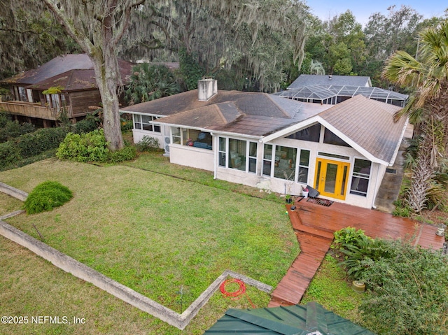 view of front facade featuring a front yard and a deck