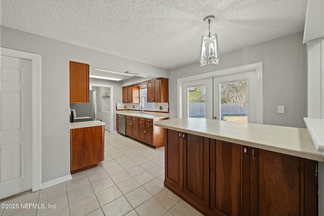 kitchen featuring stainless steel dishwasher, sink, hanging light fixtures, light tile patterned floors, and french doors