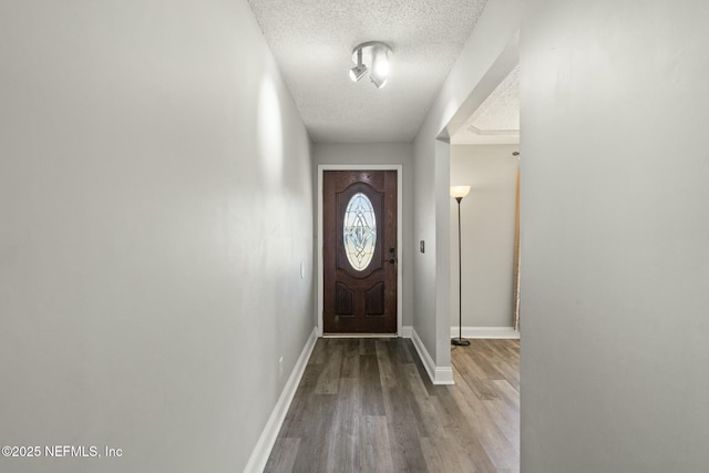 entryway featuring a textured ceiling and light hardwood / wood-style flooring