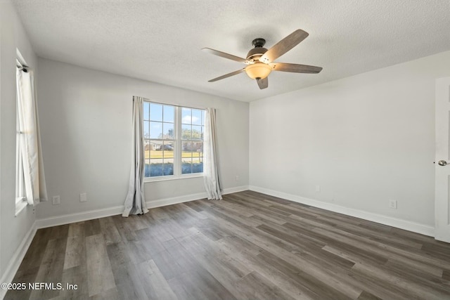 spare room featuring ceiling fan, a textured ceiling, and dark hardwood / wood-style floors