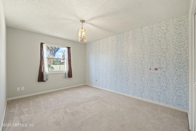 empty room with carpet and a textured ceiling