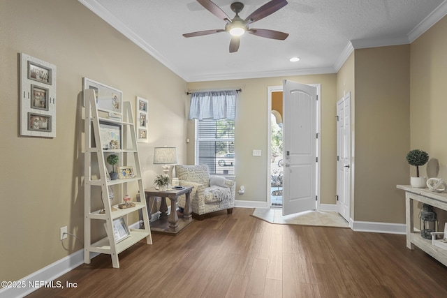 foyer entrance with ornamental molding, ceiling fan, a textured ceiling, and dark hardwood / wood-style flooring