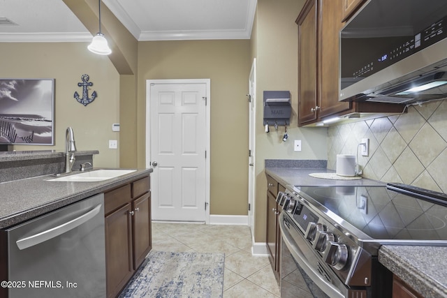 kitchen featuring sink, crown molding, pendant lighting, stainless steel appliances, and backsplash