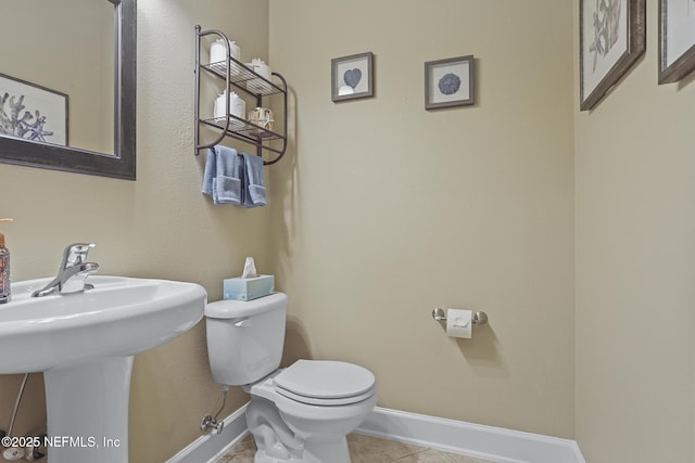 bathroom with tile patterned floors and toilet