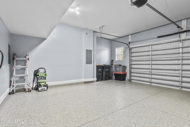 garage with a garage door opener and electric panel