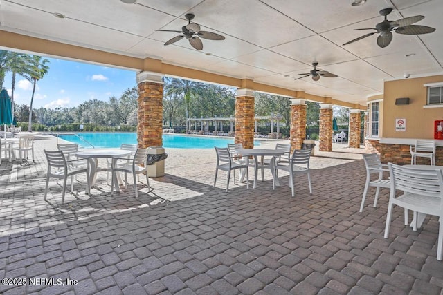 view of patio / terrace with an outdoor bar and a community pool