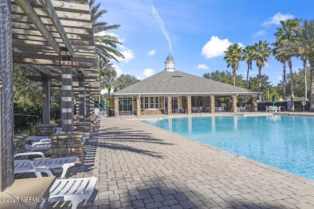 view of pool with a patio and a pergola