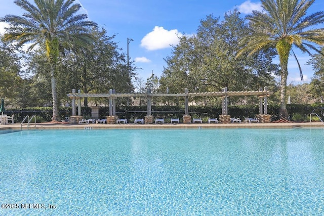 view of swimming pool with a pergola