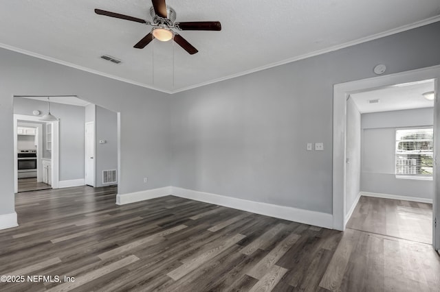 unfurnished room with dark wood-type flooring, ceiling fan, ornamental molding, and a textured ceiling