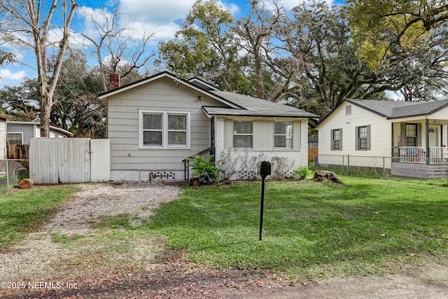 bungalow-style home with a front lawn