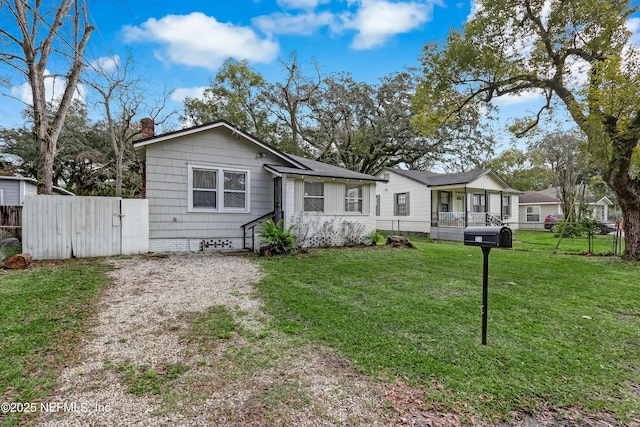 view of front of home featuring covered porch and a front yard