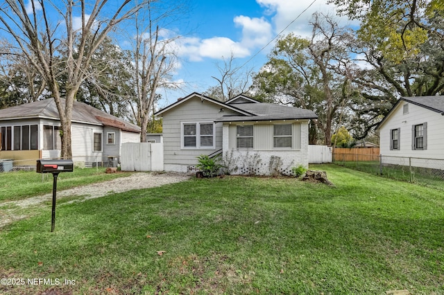 view of front of home featuring a front lawn and a sunroom