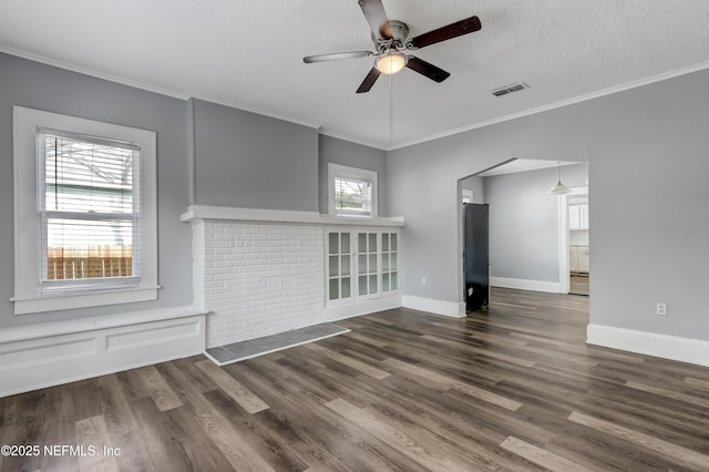 unfurnished living room with ceiling fan, dark hardwood / wood-style flooring, crown molding, and a textured ceiling