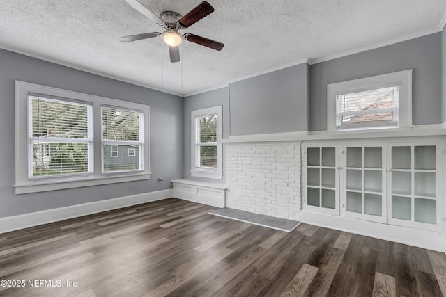 spare room with plenty of natural light, a textured ceiling, and crown molding