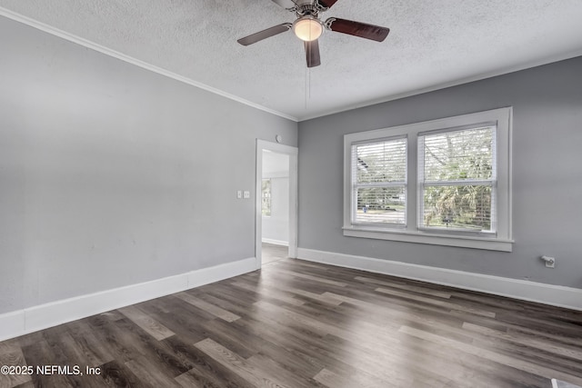 spare room with ceiling fan, dark wood-type flooring, a textured ceiling, and ornamental molding